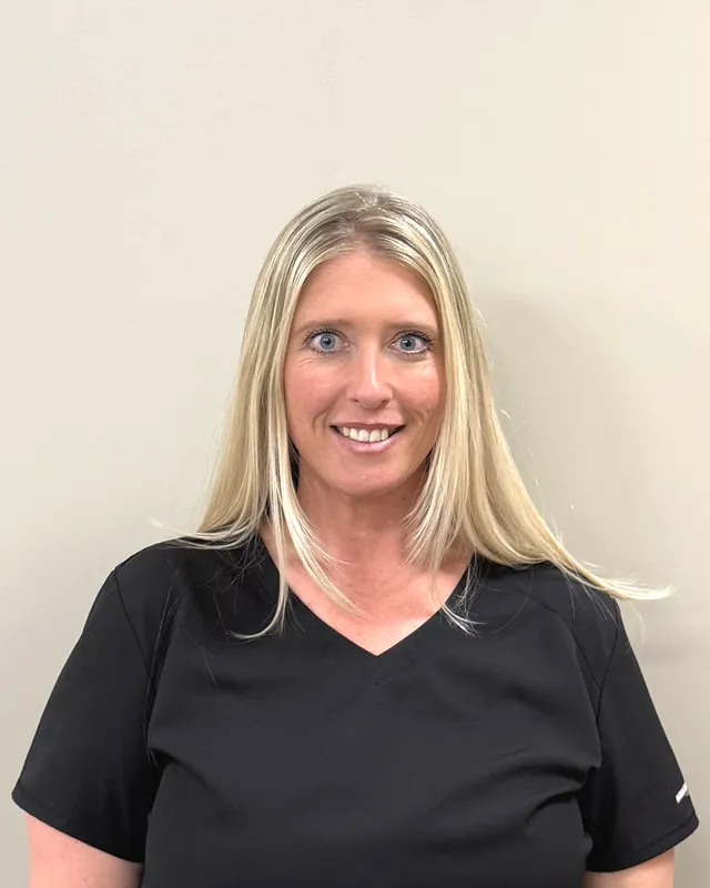 Jeni Ebertshauser, PA-C, physician assistant at Health First Urgent Care, in a black v-neck scrub top