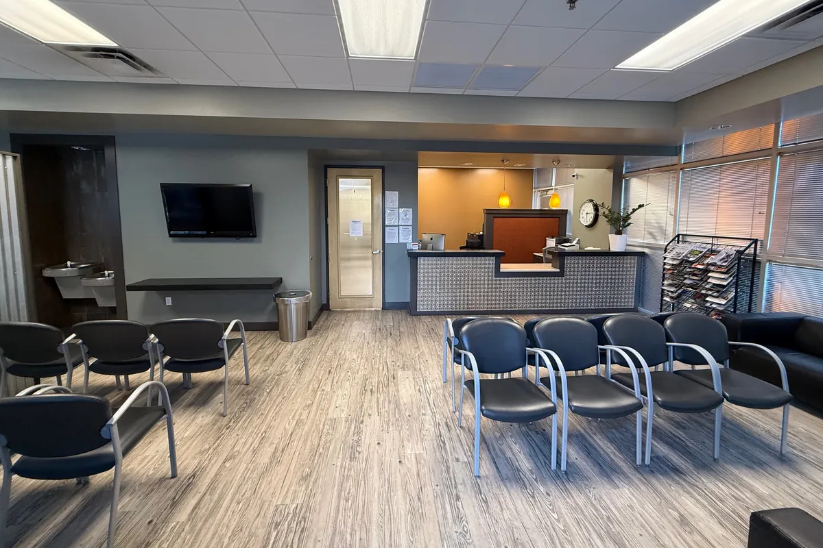 The front reception desk and rows of waiting room chairs inside Health First Urgent Care